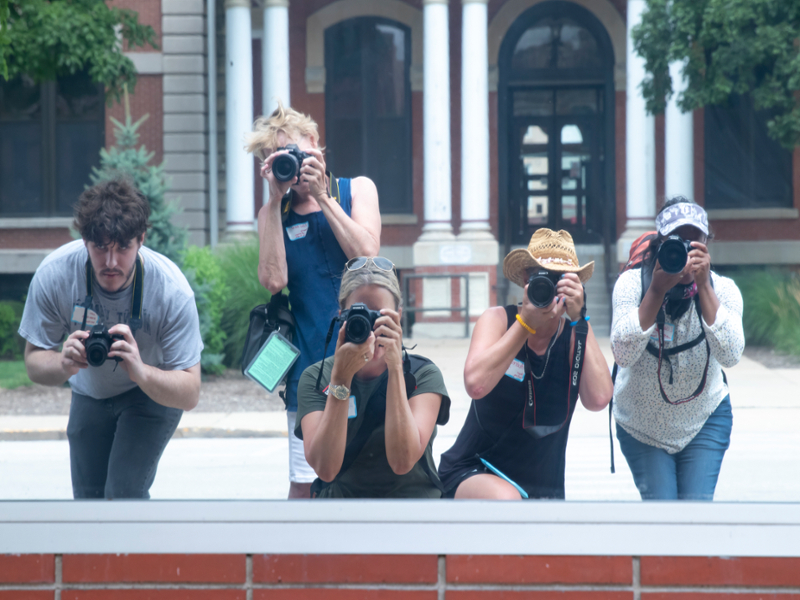 Students taking picture near courthouse.